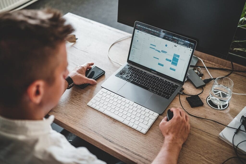 Marketer reviewing a CRM dashboard on a laptop at a desk